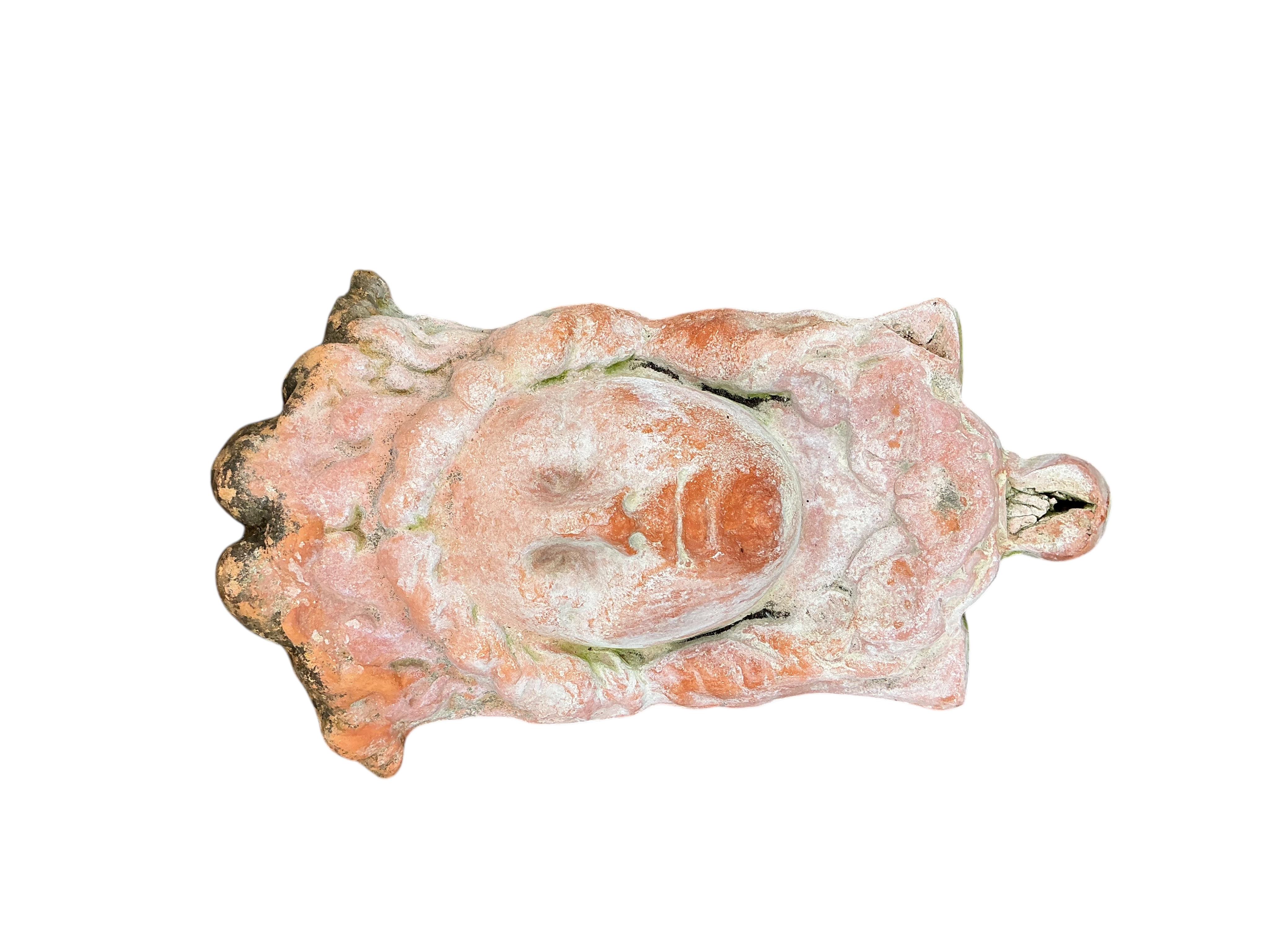 A pair of terracotta mask wall pockets, height 44cm